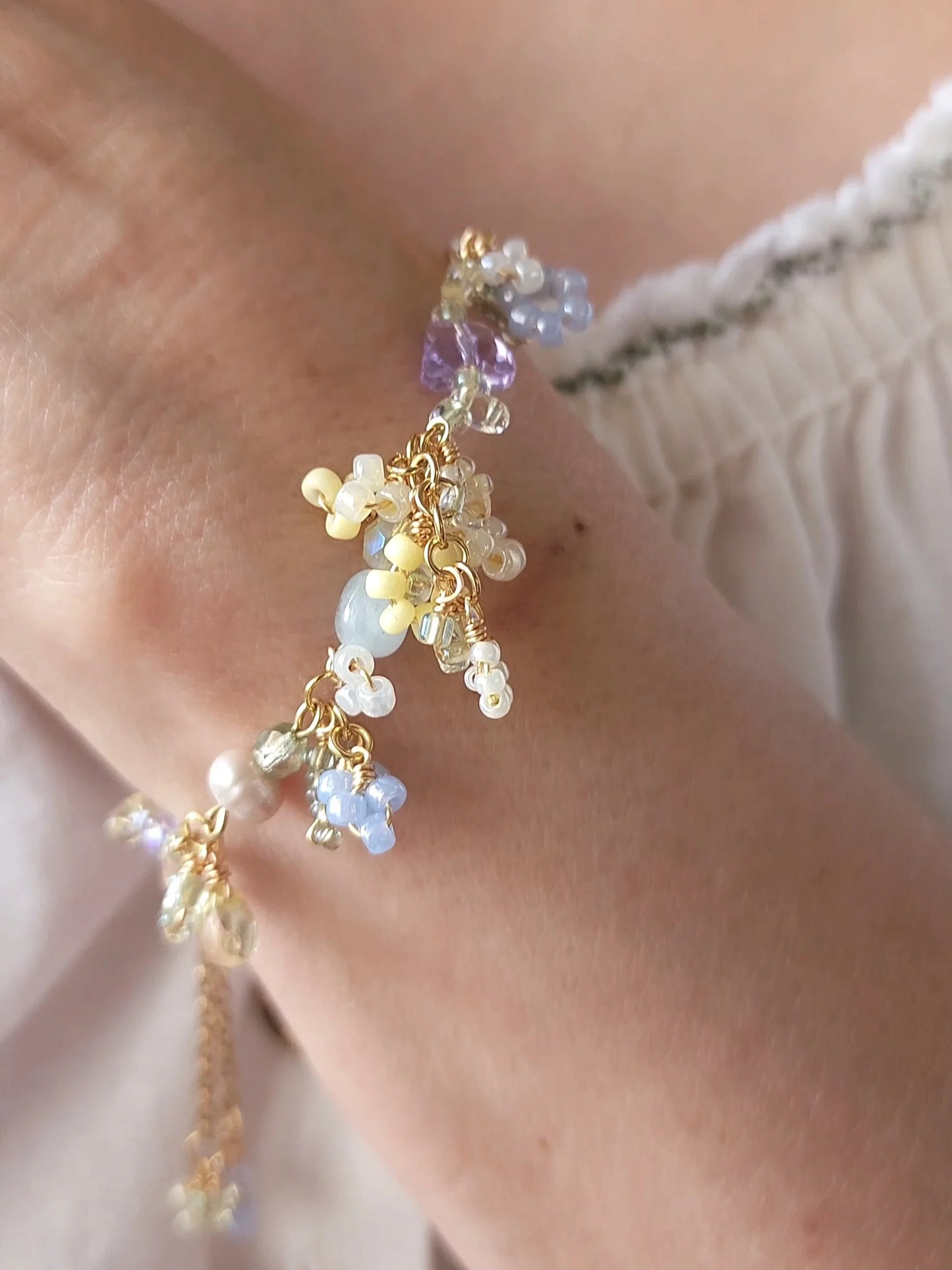 Multicolored beaded bracelet on a wrist with a soft background