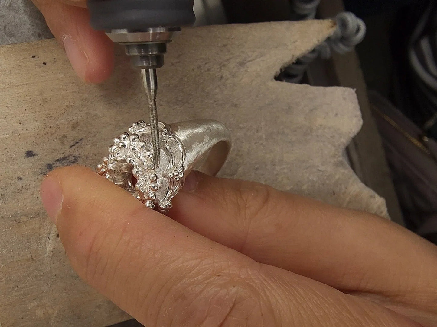 Working on a silver ring at the bench.