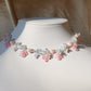 This Candy Rose Choker is handcrafted from silver-plated brass, stainless steel findings and tarnish-resistant copper wire. Its opalite beads give it a stunning opalescent finish, and it is adorned with bright pink, flower-like details made of glass beads for added sweetness.