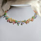 A vibrant pastel necklace with flower and leaf details made of seed beads. Green aventurine and citrine gives the impression of a warm afternoon in the forest with enchanting seed bead flowers and plants in pastel pink, purple, yellow, and green. A dreamy piece fit for forest fairies.